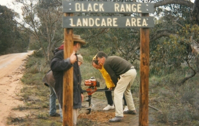 Landholders erecting sign on Bunjil's Cave Rd.
